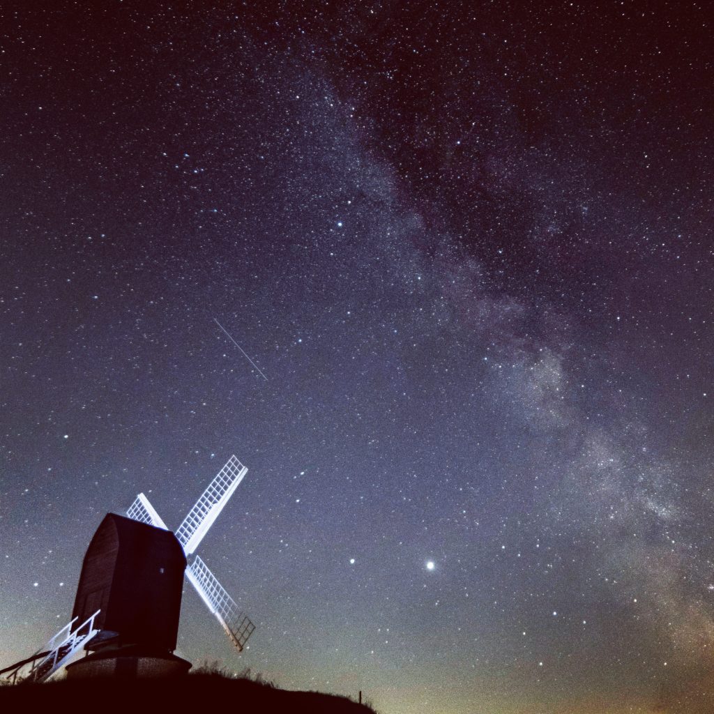 white and black windmill under starry night